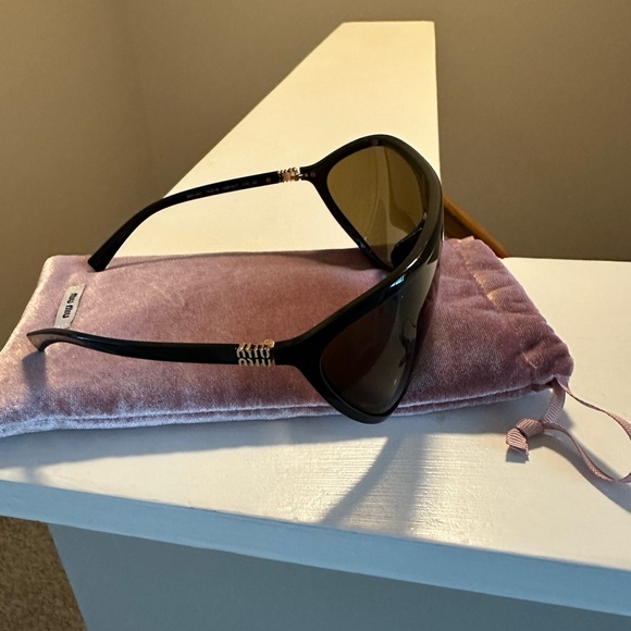 Miu Miu Elegant Black Sunglasses with Gold Accents - Picture 1 of 5